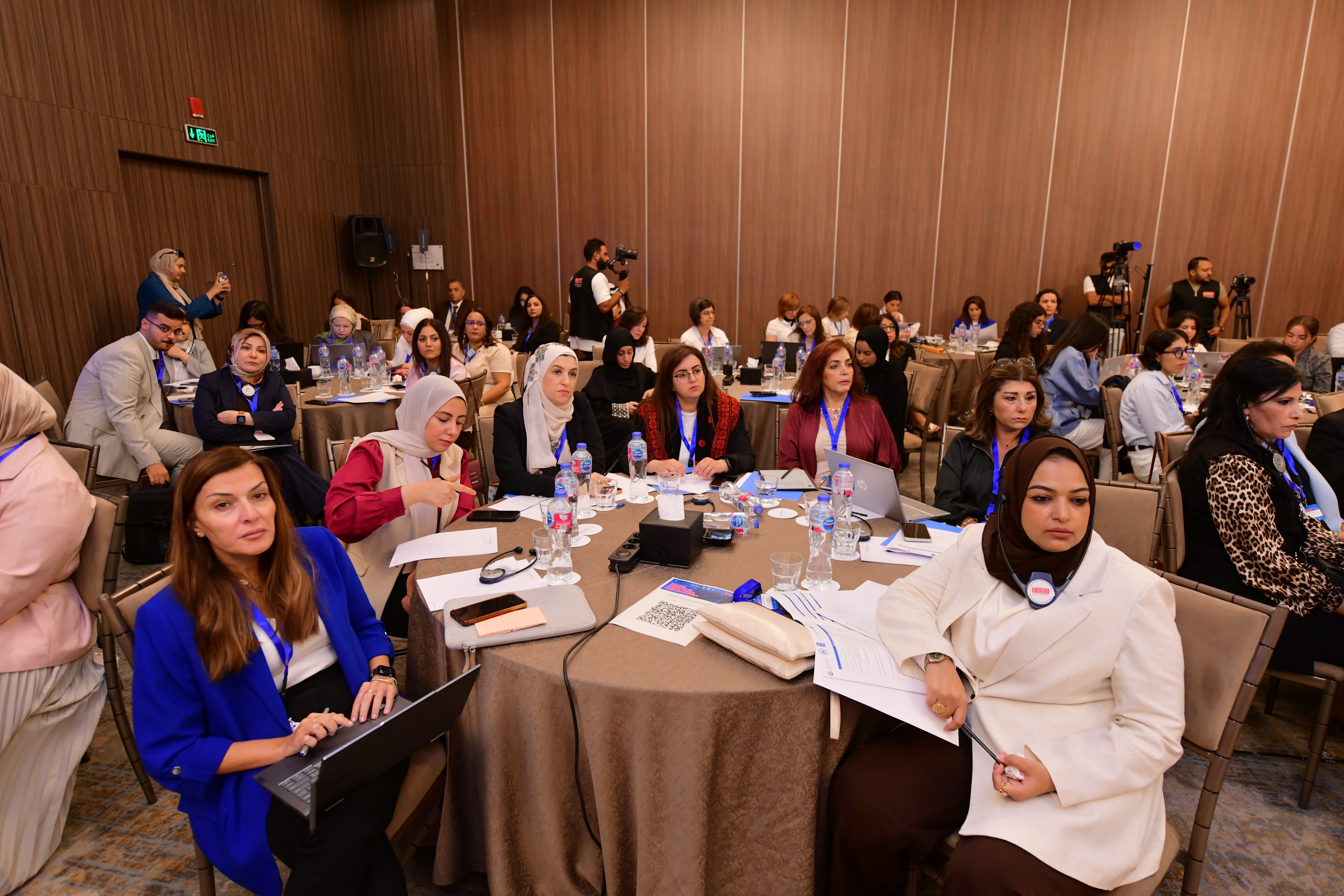 Wide shot of participants behind tables