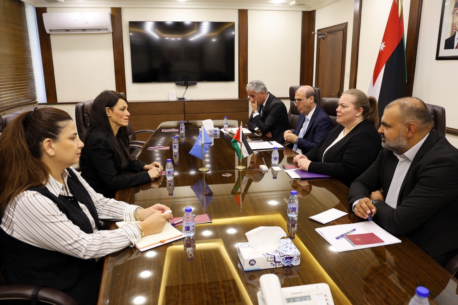 Two delegations seated at a meeting table