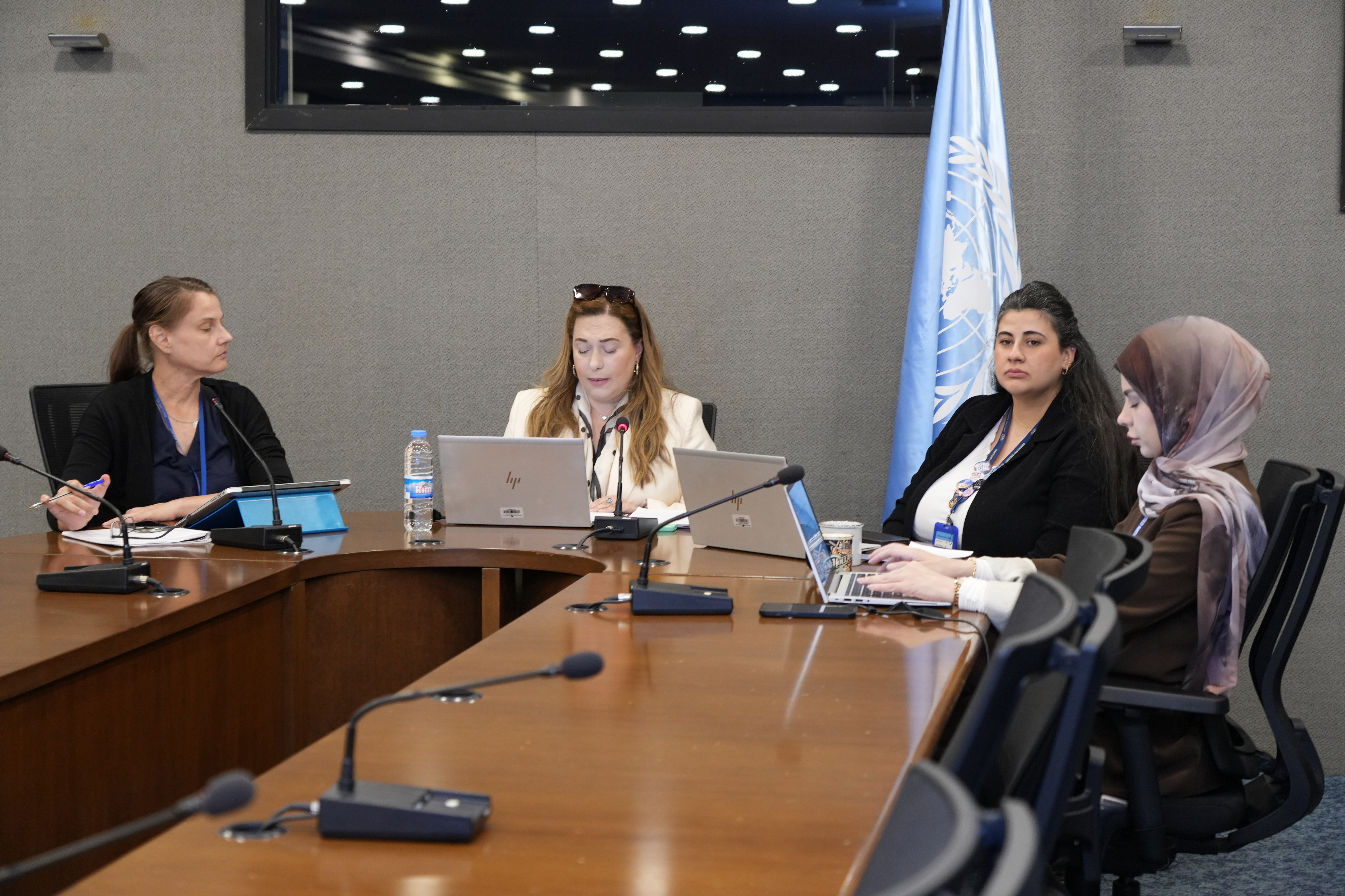 Four people around a table and microphones