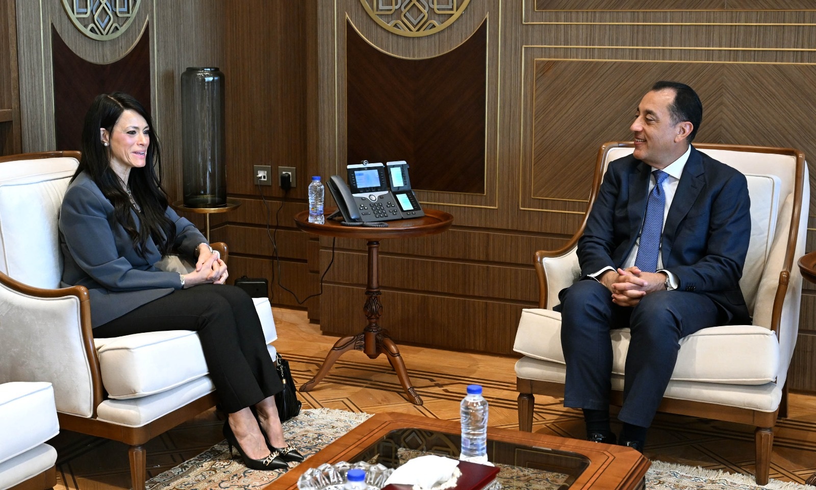 Two officials seated in a visit setup