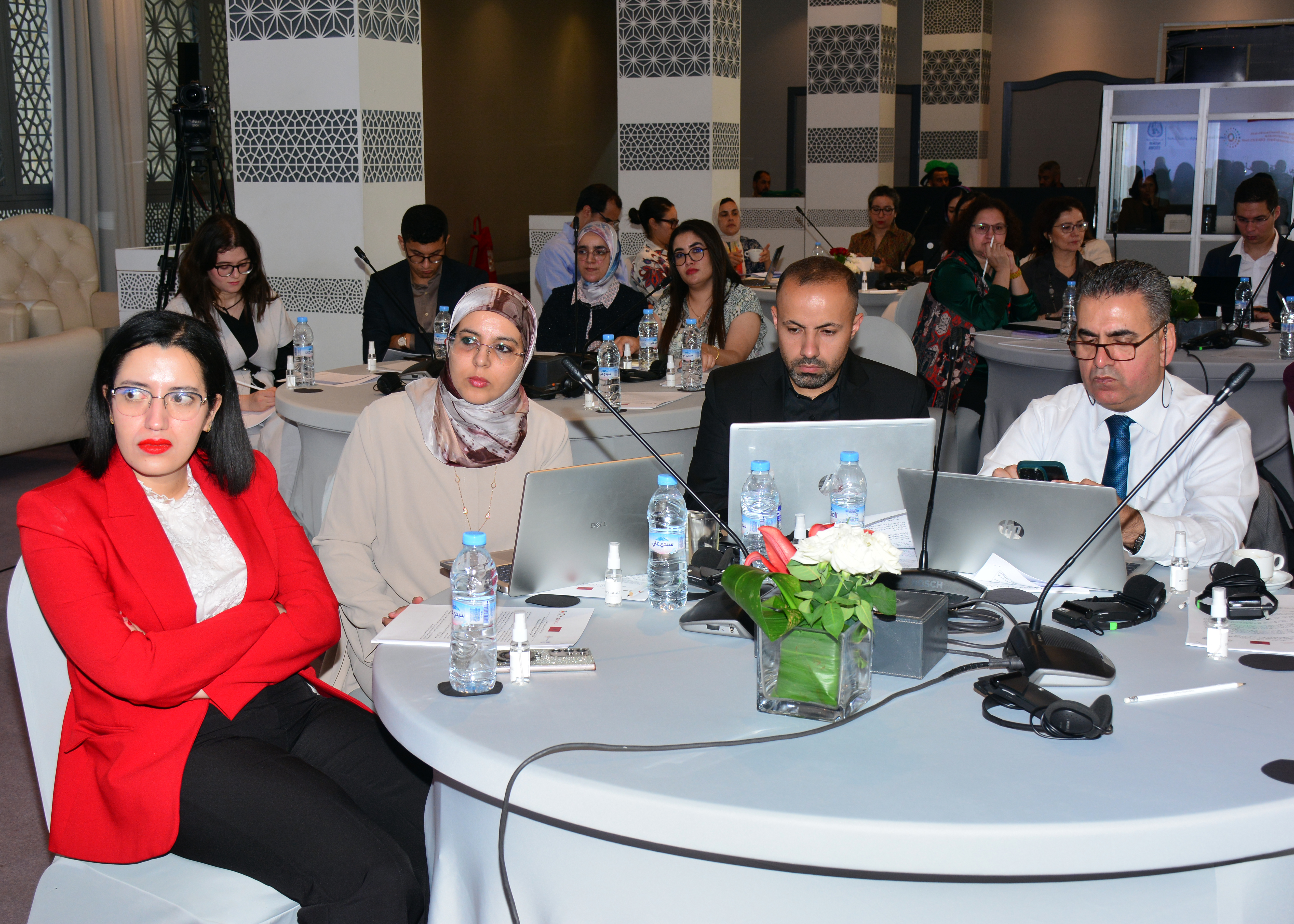part of the audience behind round tables