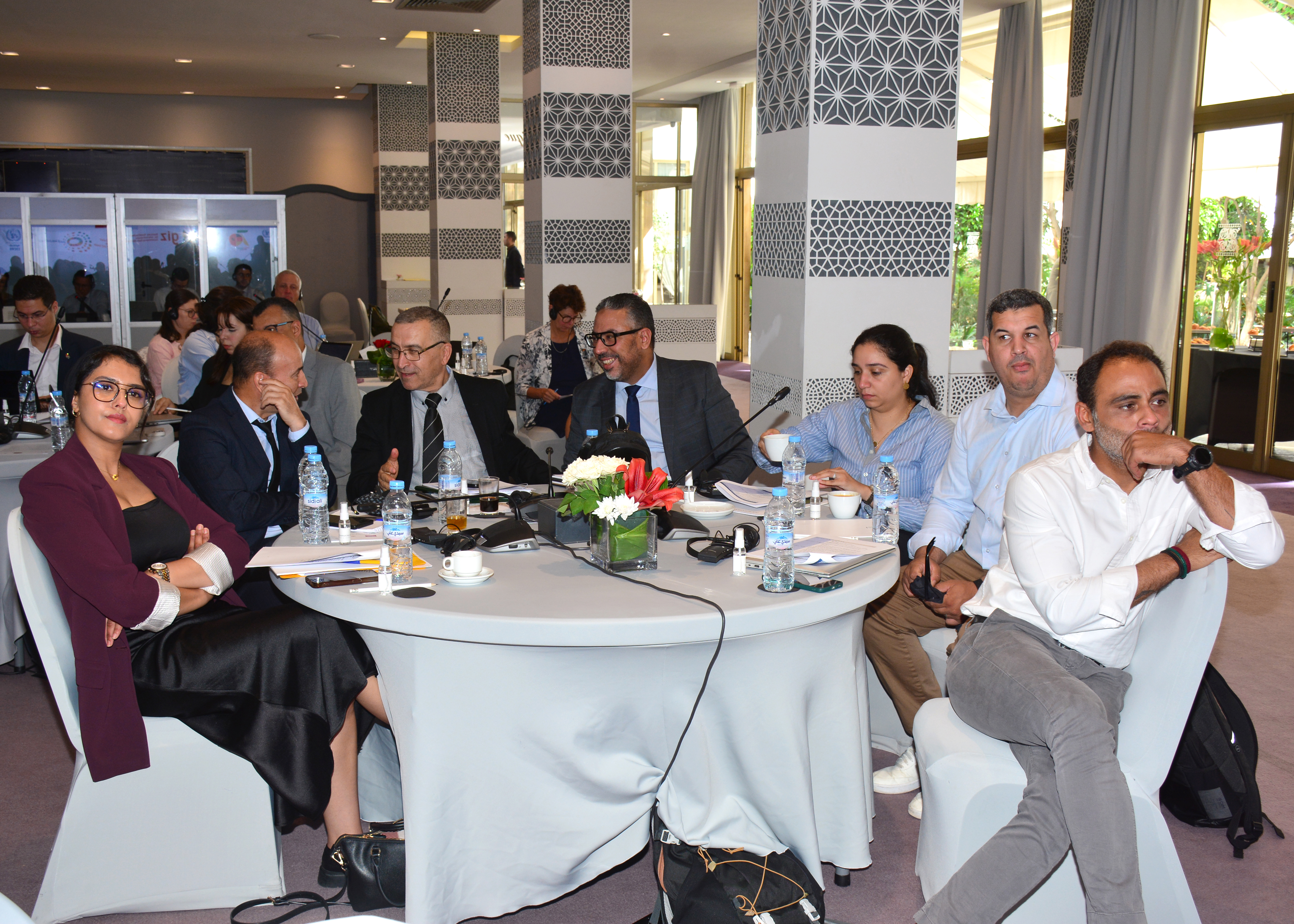 part of the audience behind round tables