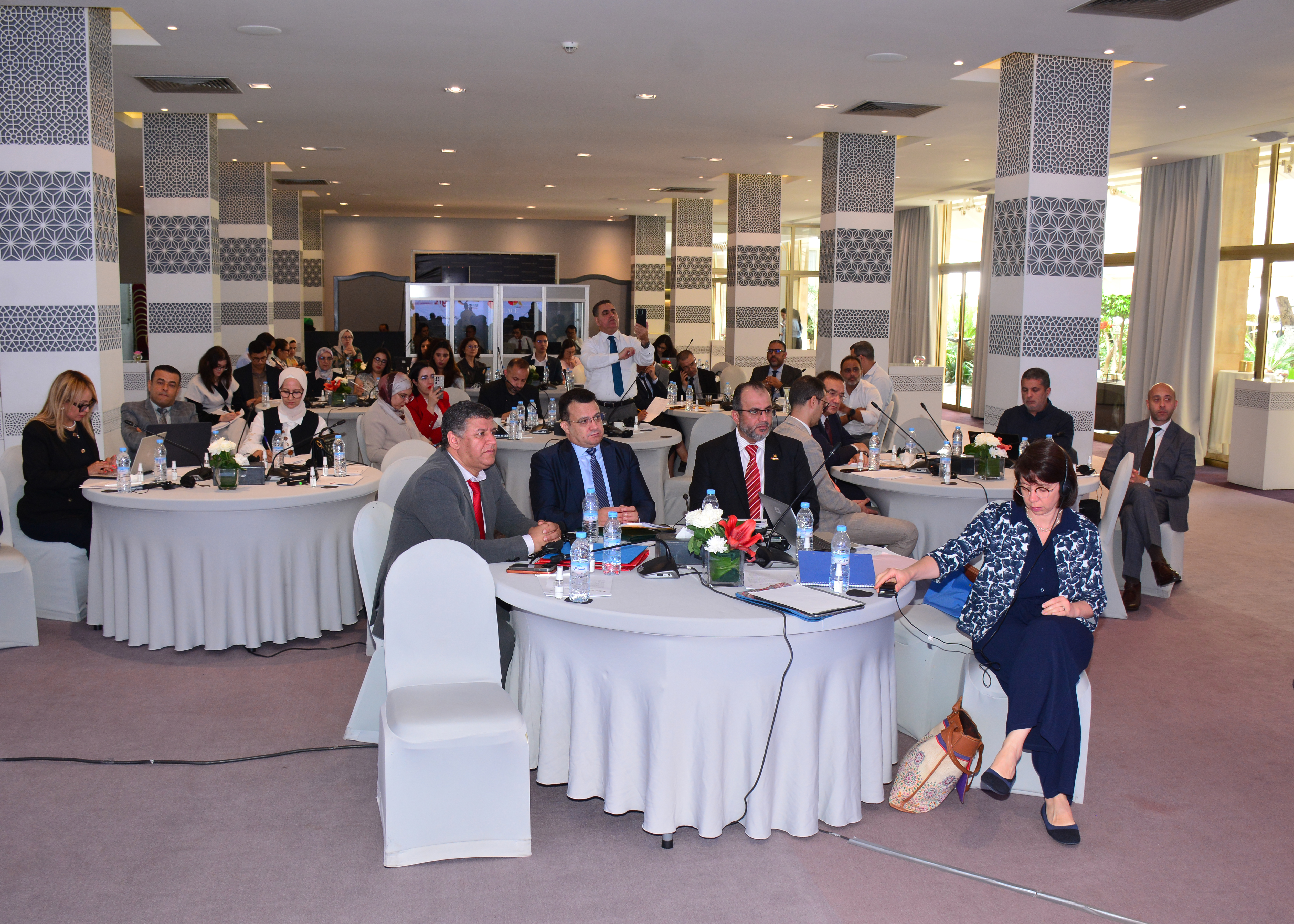 part of the audience behind round tables