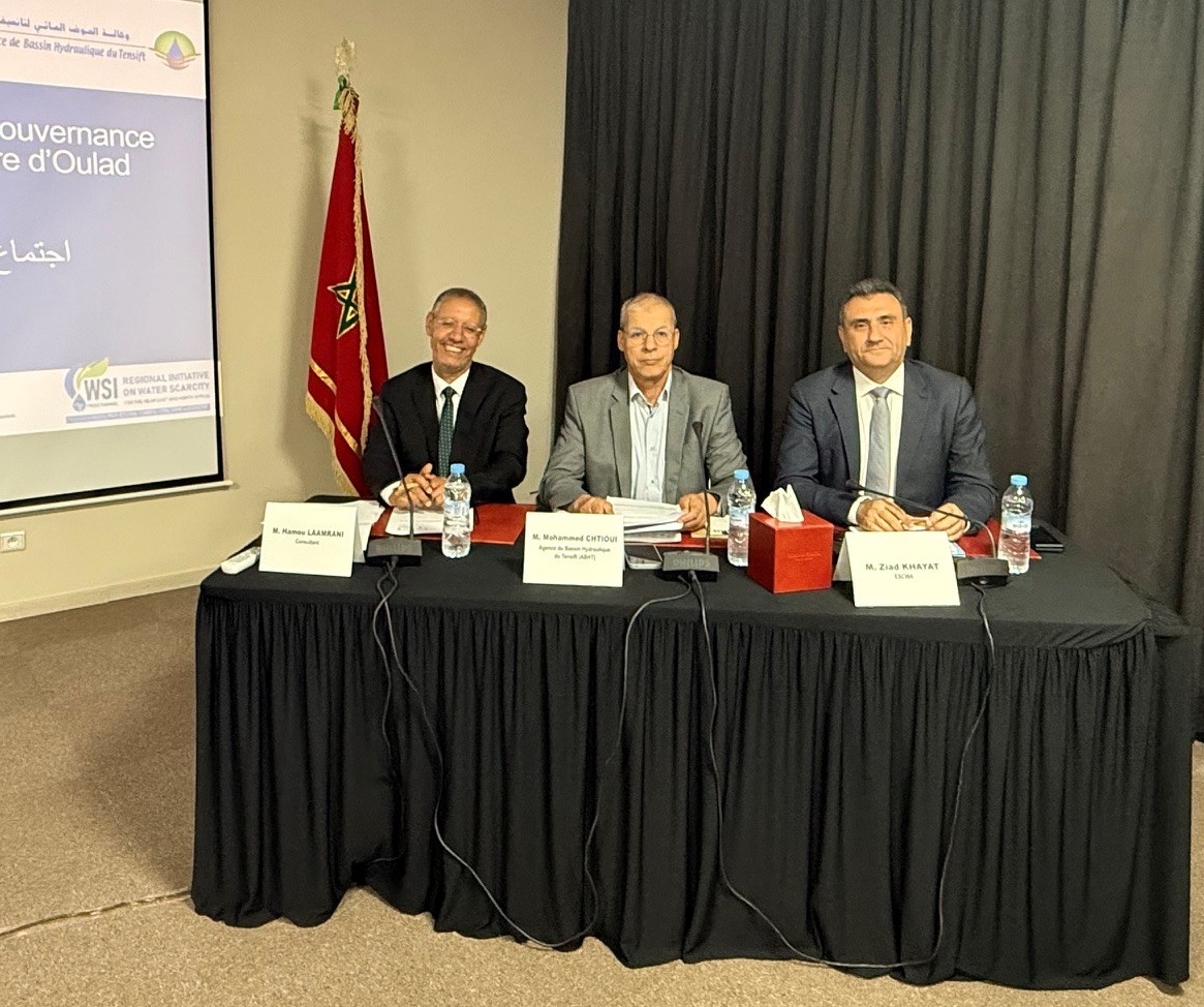 three speakers seated behind a table