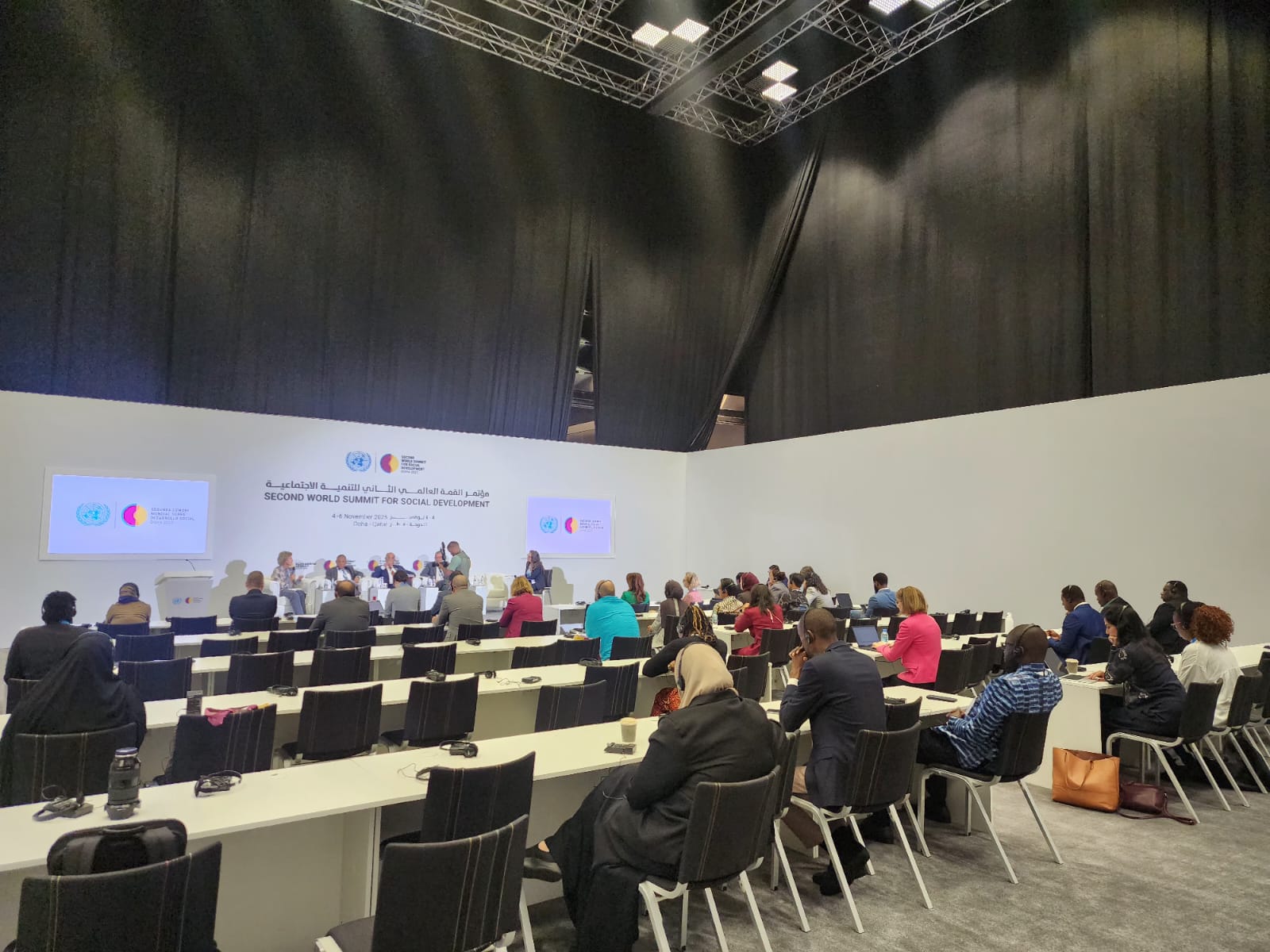 People behind a large table and a panel