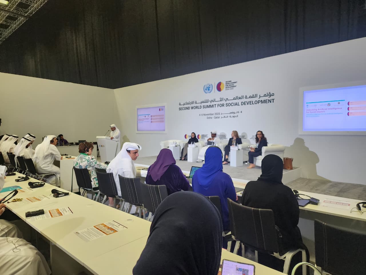People behind a large table and a panel