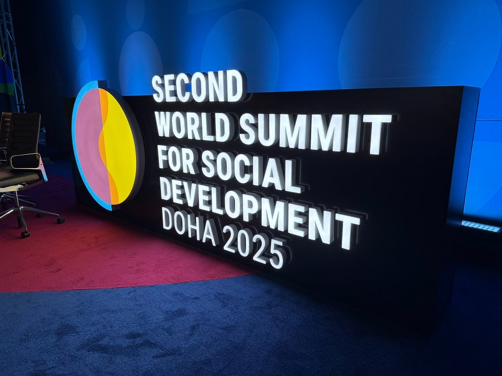 Banner reading the World Social Summit title