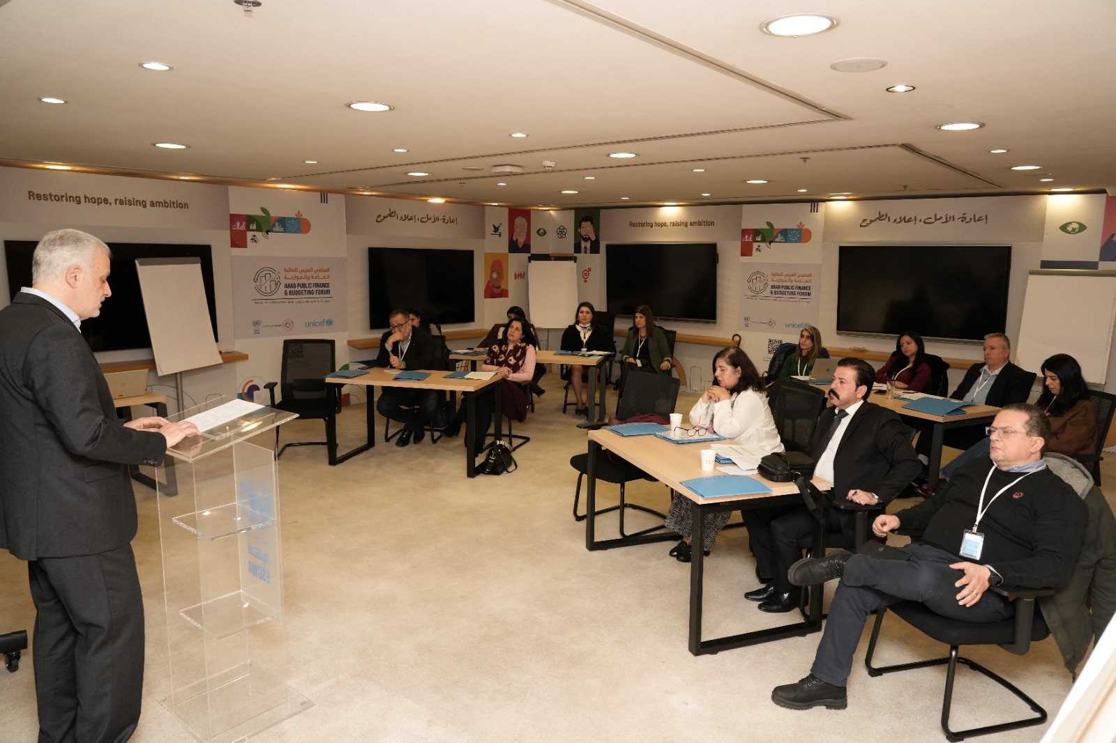 Presenter standing in front of group of participants