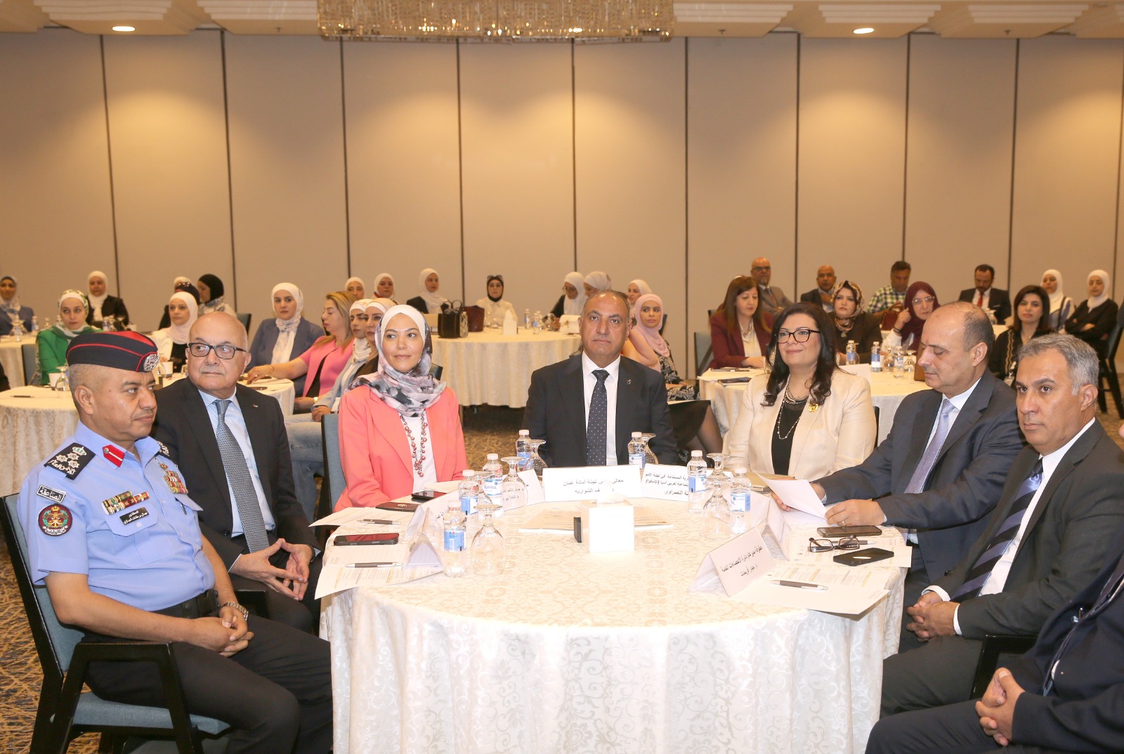 part of the audience seated at round tables
