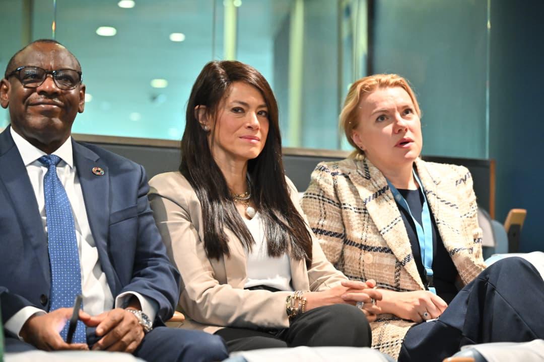 Three people seated in the audience