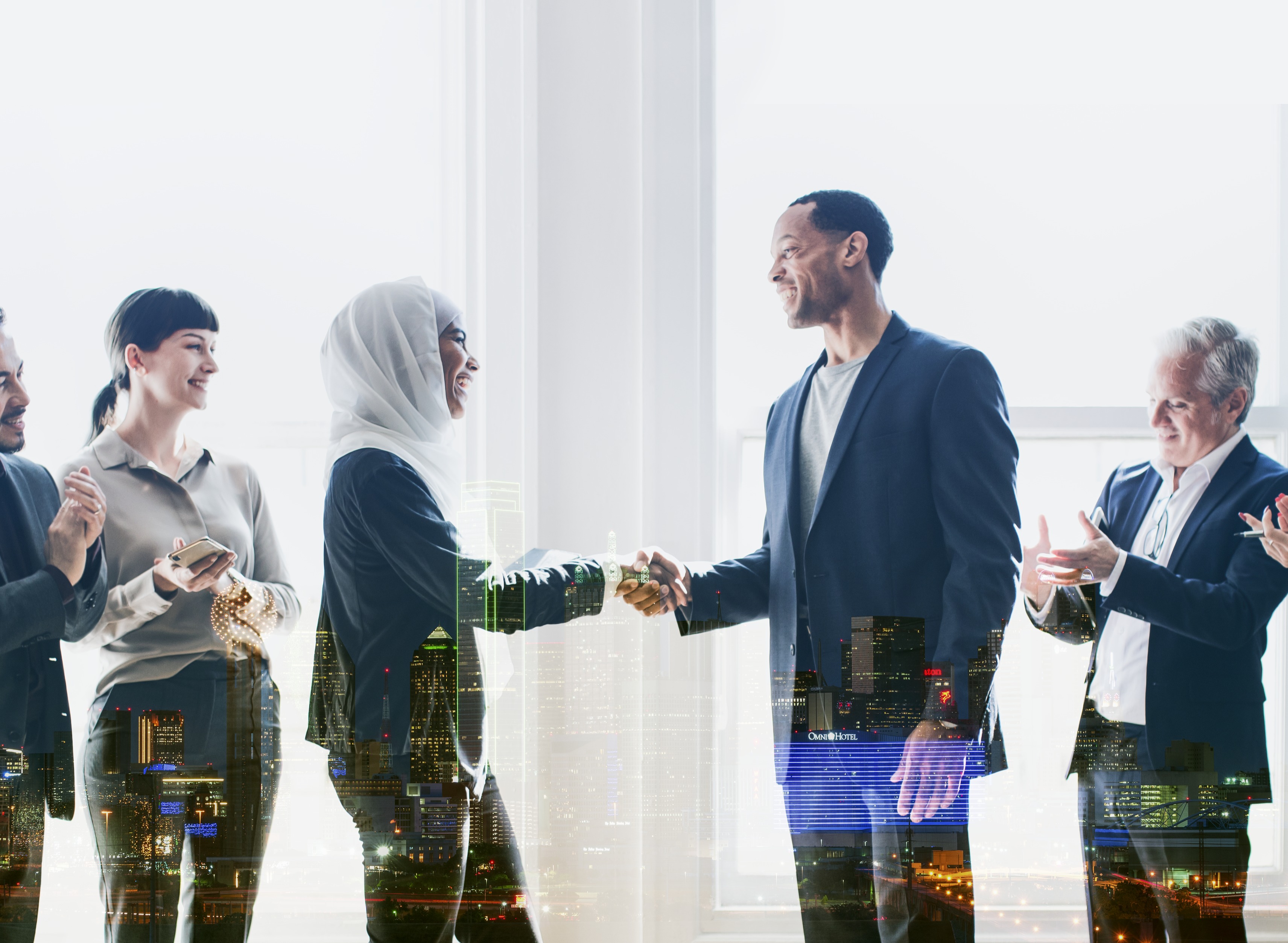 A man and a woman each surrounded by other people greeting each other