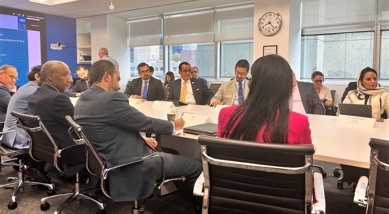 People seated around a table listening