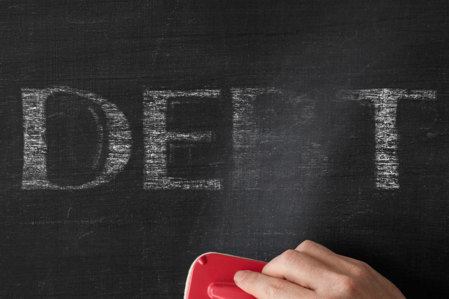 Erasing the word debt off a board. istock image