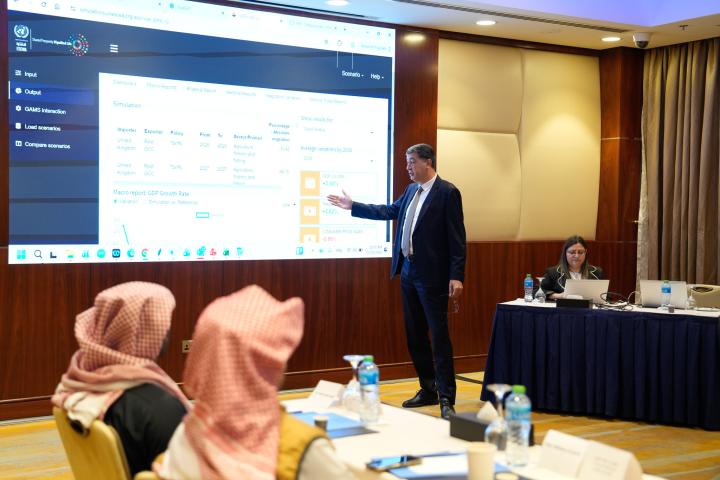 Man presenting on a whiteboard screen