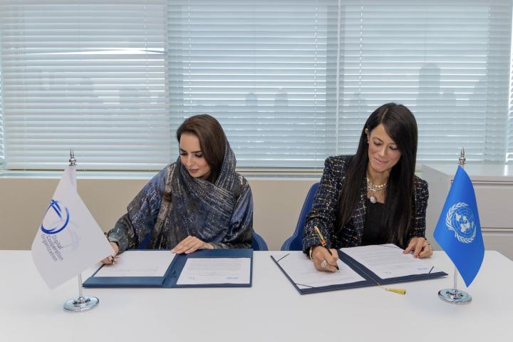 Two women senior officers signing documents at a table