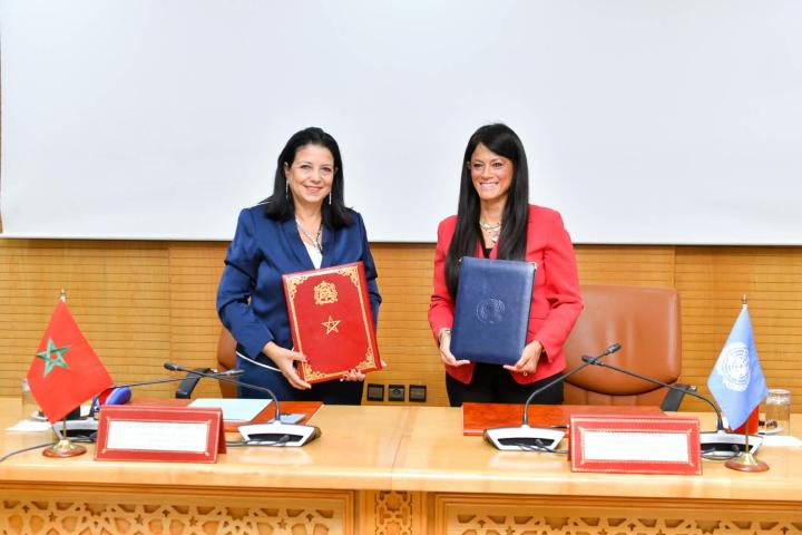 Two women senior officers holding a folder they just signed