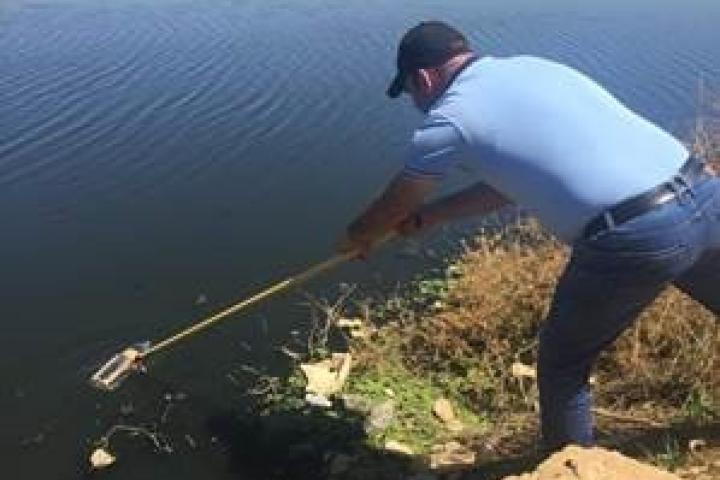 A person cleaning the river