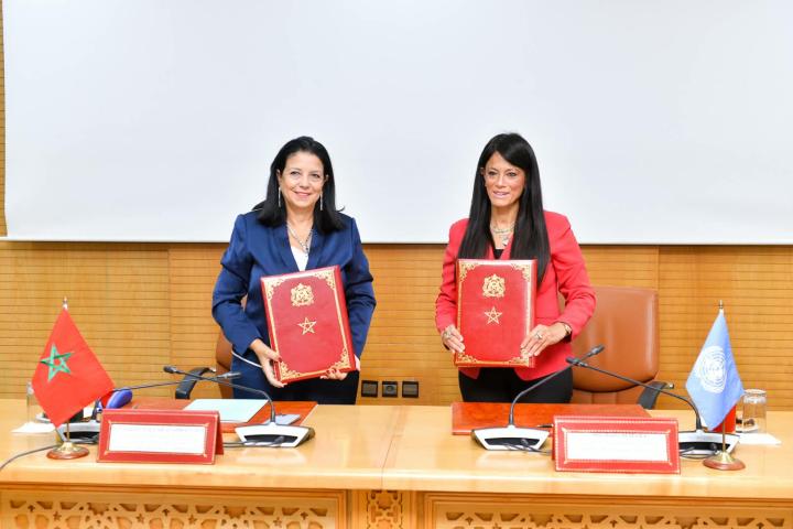 Two women senior officers holding a folder they just signed